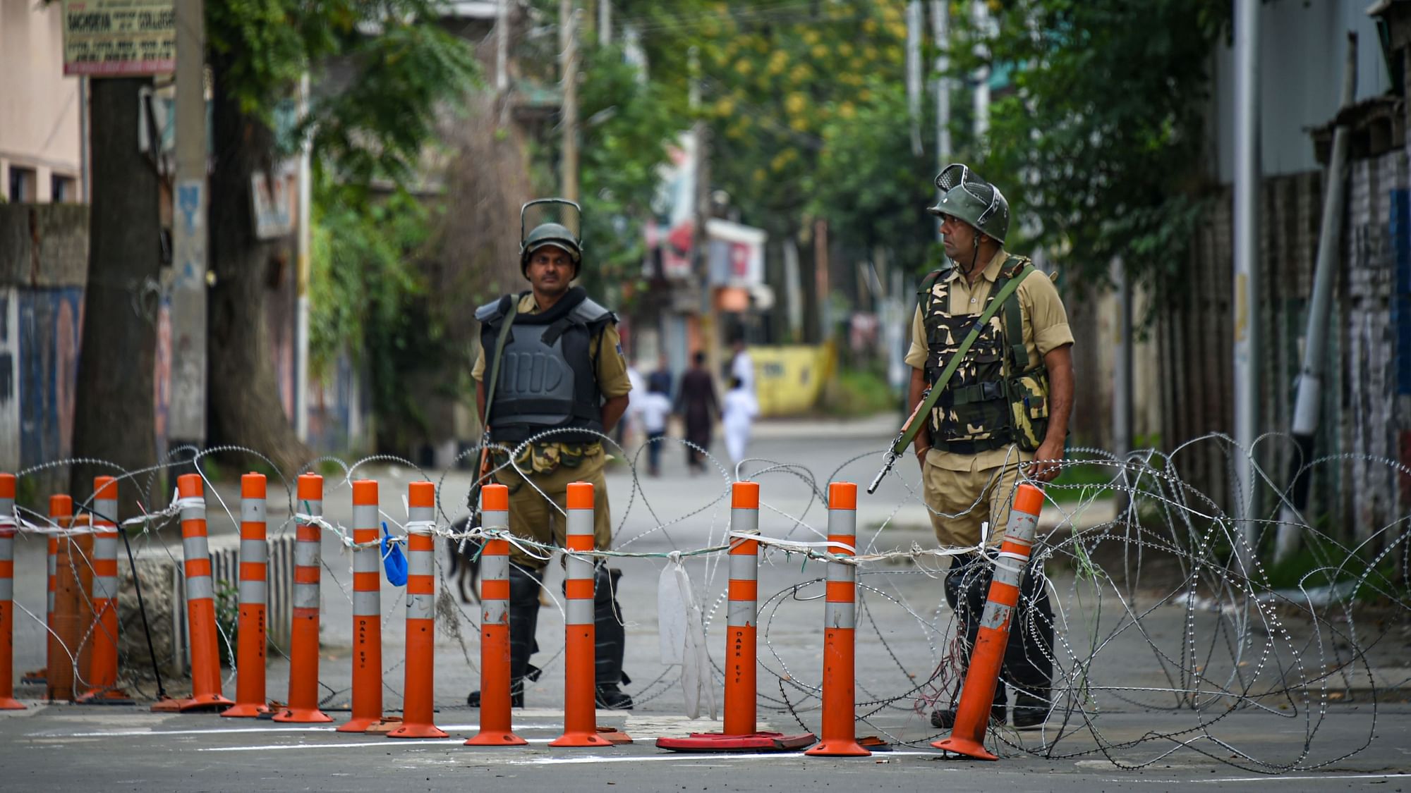 Security personnel stand guard during restrictions, in Srinagar