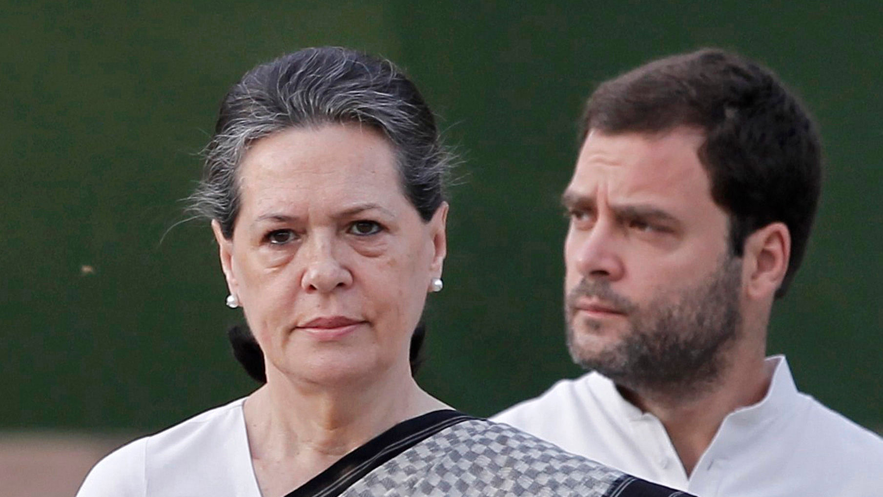 Sonia Gandhi (left) and Rahul Gandhi looking on.&nbsp;