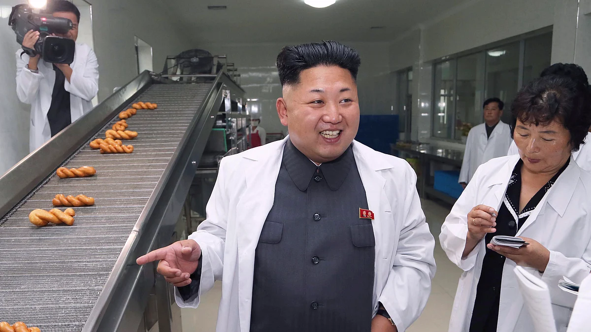 North Korean leader Kim Jong Un smiles as he gives field guidance during a visit to a food factory. (Photo: Reuters)