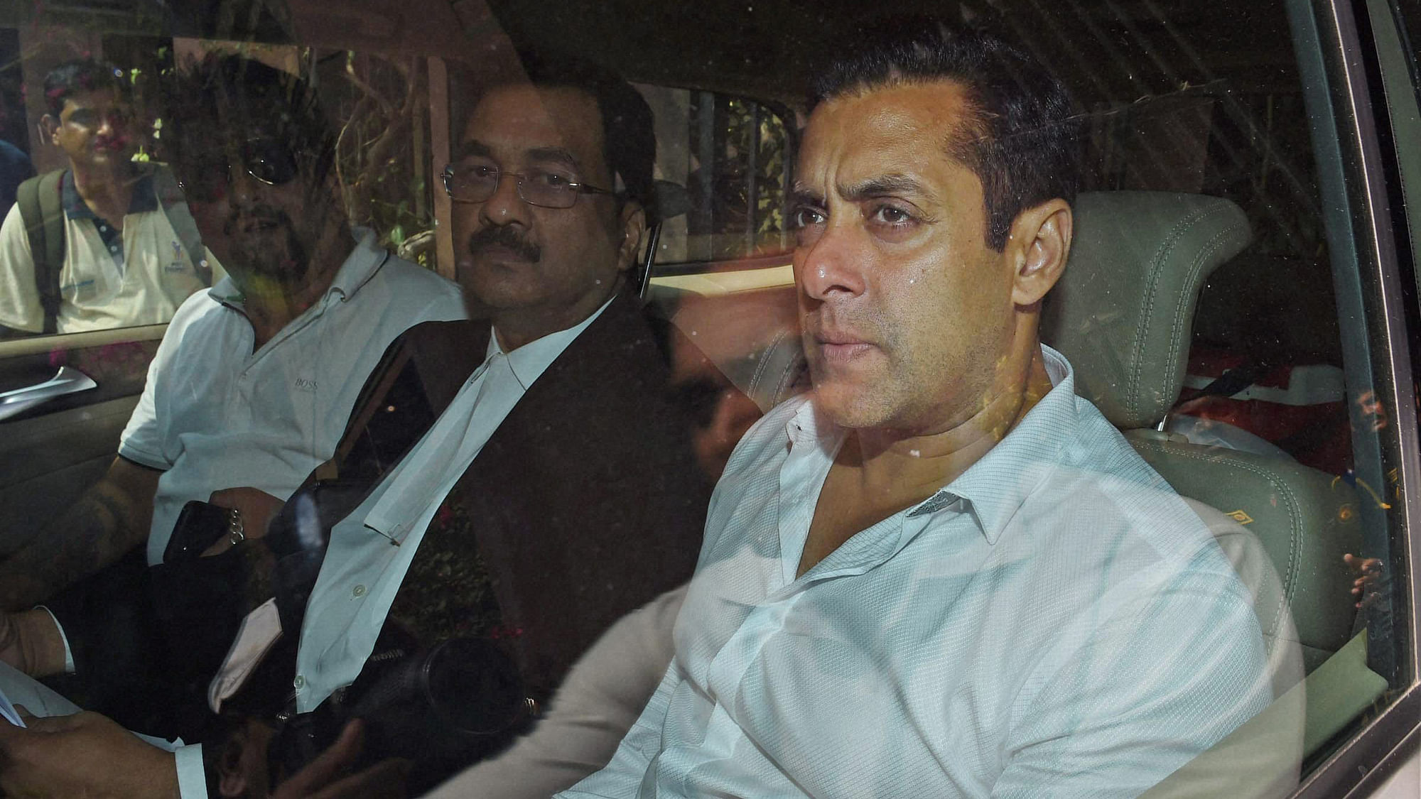 Bollywood actor Salman Khan, right, sits in a car outside a court in Mumbai outside the court. (Photo: AP)