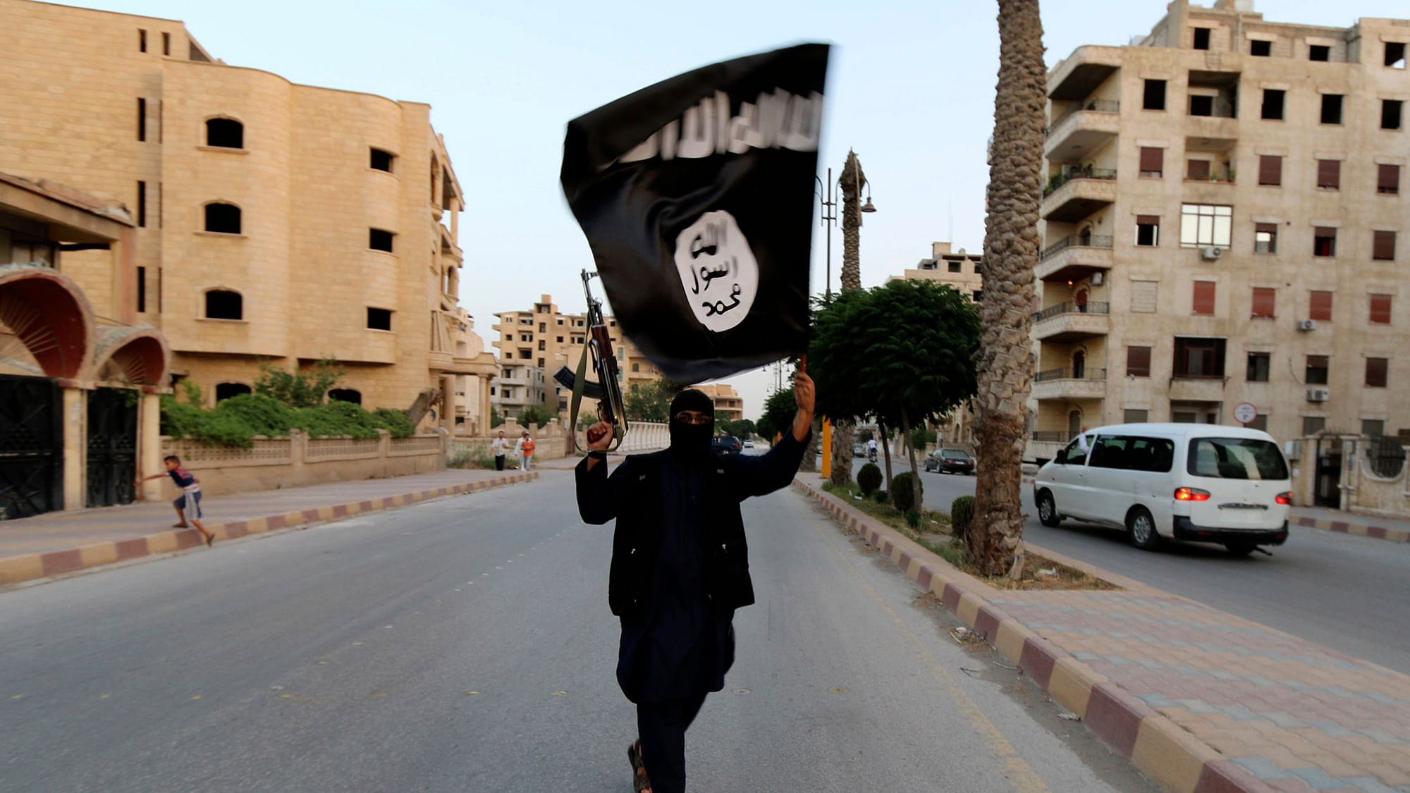 A member loyal to the Islamic State in Iraq and the Levant (ISIL) waves an ISIL flag in Raqqa June 29, 2014. (Photo: Reuters)