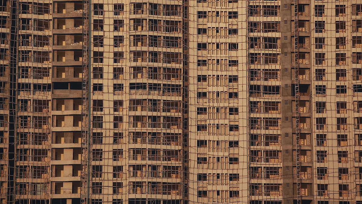 Windows of various apartments of an high-rise residential building under construction, are seen in a suburb of Mumbai. 