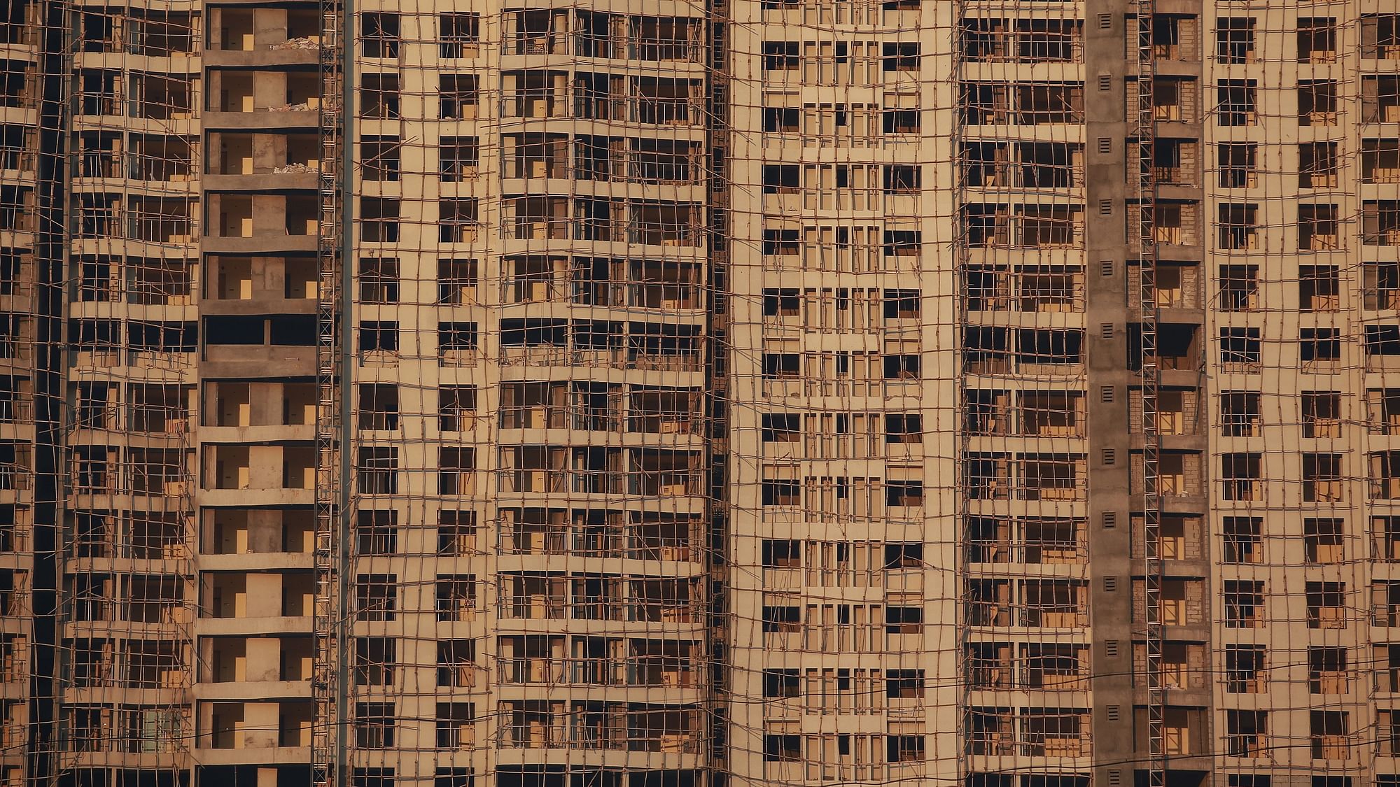 Windows of various apartments of an high-rise residential building under construction, are seen in a suburb of Mumbai. Representational Image.