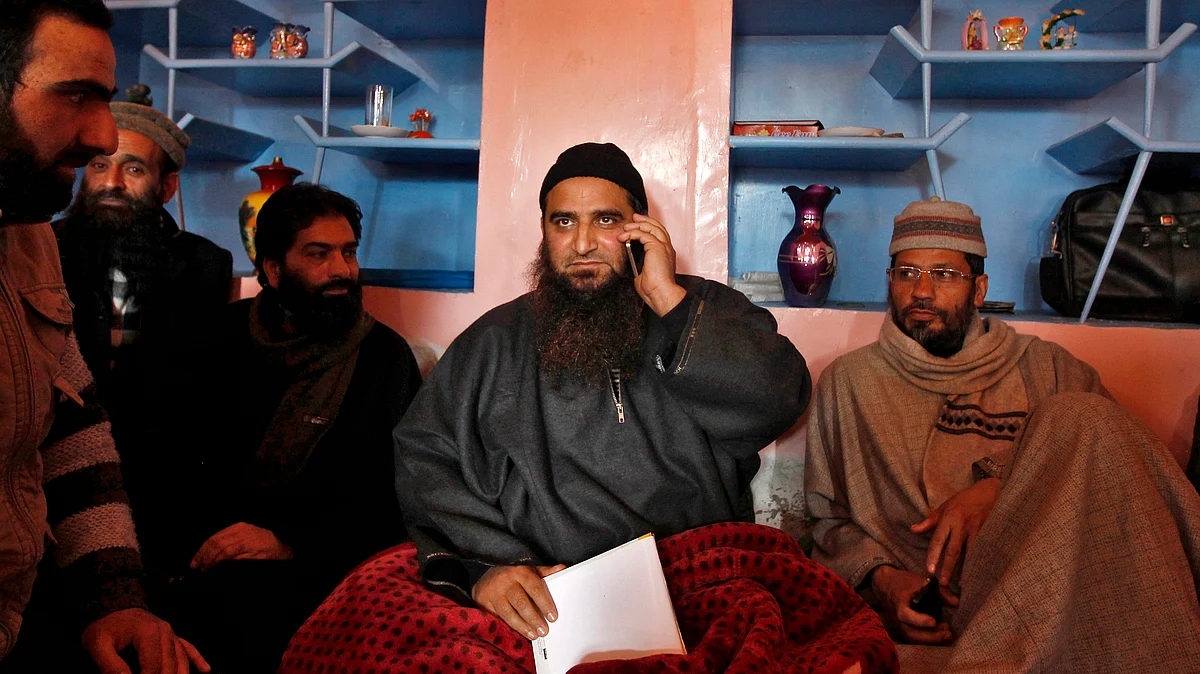 Kashmiri separatist leader Masarat Alam speaks on his mobile phone at his residence in Srinagar. (Photo: Reuters)