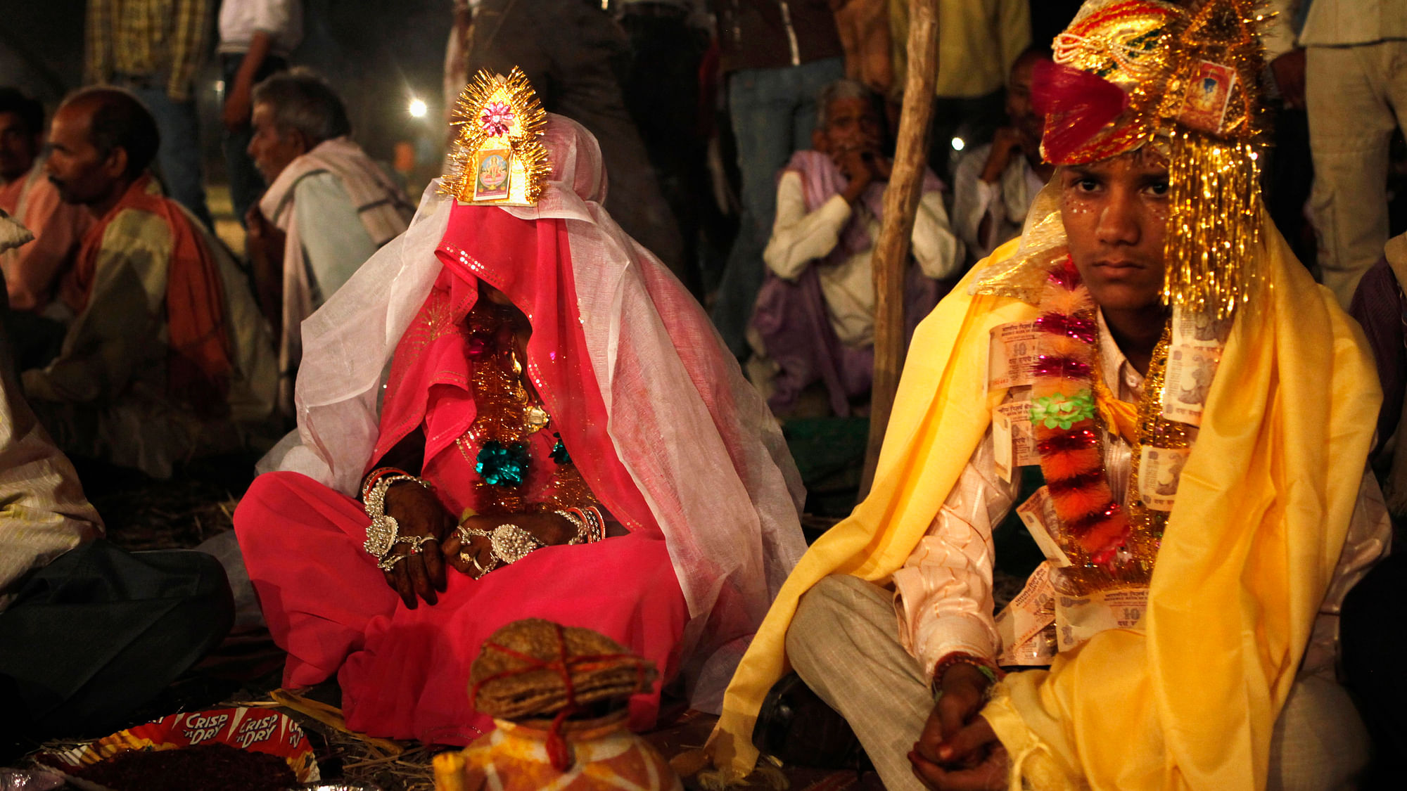 Kishan Gopal (R), 15, sits with his 12-year-old newly-wed wife Urmila in a mass marriage outside his village near Kota, Rajasthan. (Photo: Reuters)