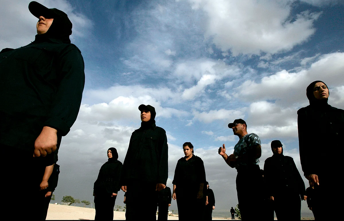 Members of the Palestinian security forces stand at attention and listen to their commanding officer (3rd R) at their training facility in the West Bank town of Jericho, November 20, 2007. (Photo: Reuters)