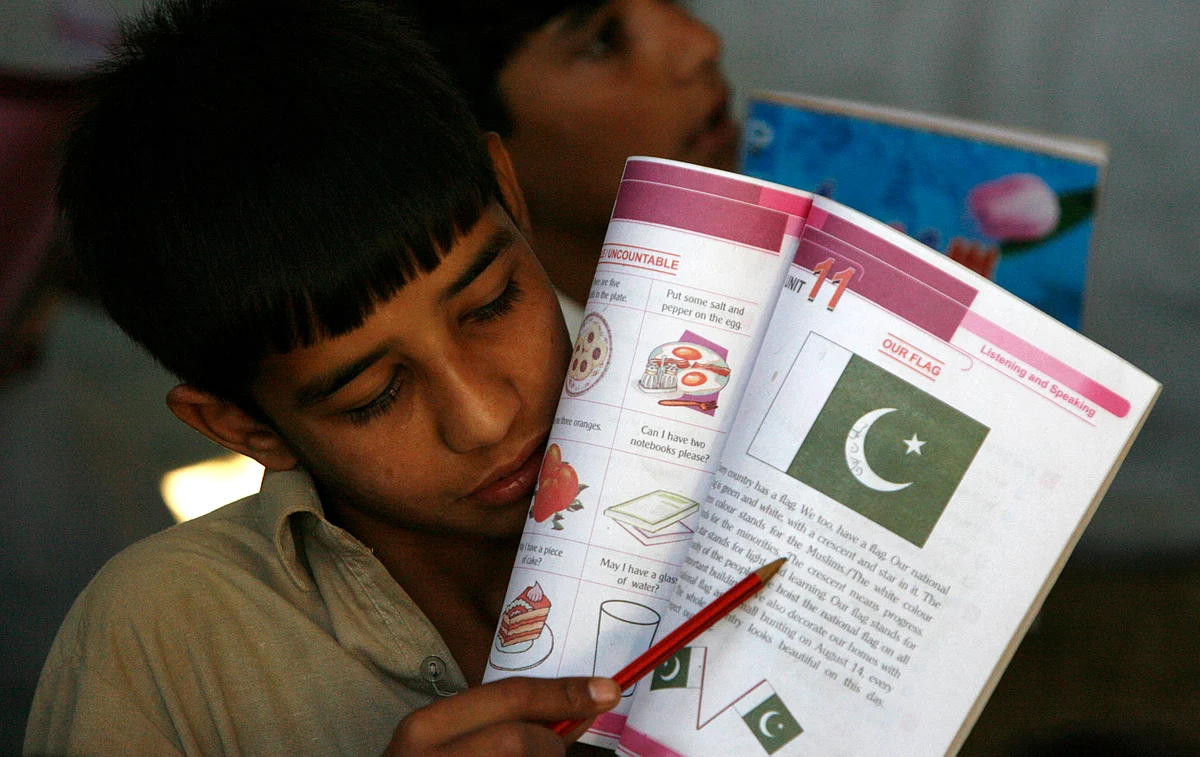 A Pakistani School boy reads a passage from his book. (Photo: Reuters)