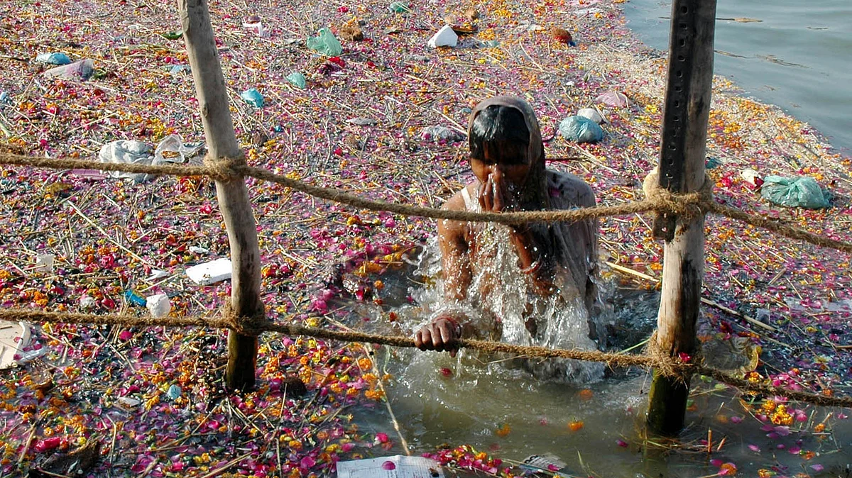 A devotee takes a dip in the polluted river Ganga which is believed to wash away all sins. (Photo: Reuters)