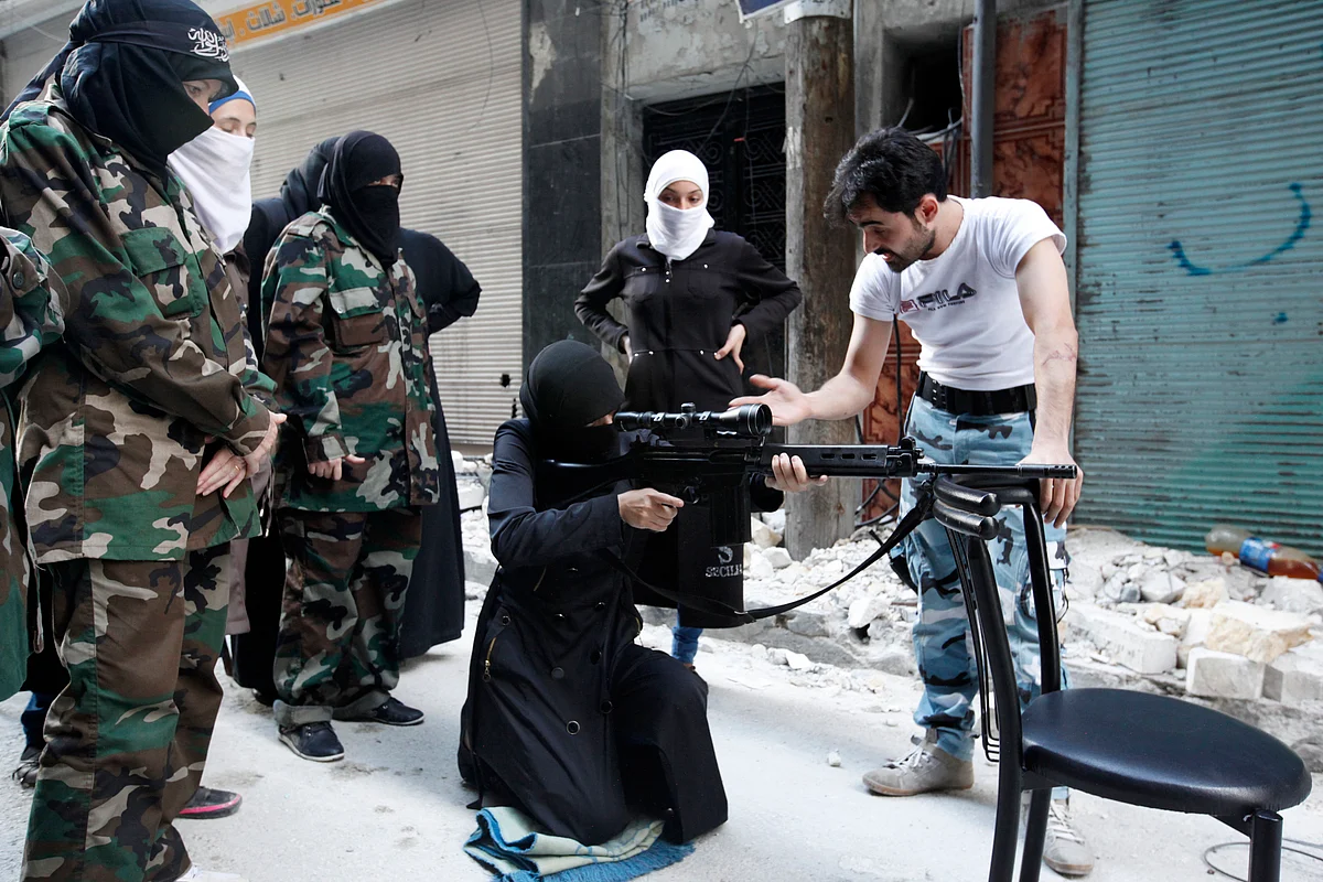 <!--StartFragment-->A female member of the ‘Mother Aisha’ battalion receives instructions as she holds a rifle during military training in Aleppo, Syria. (Photo: Reuters)<!--EndFragment-->