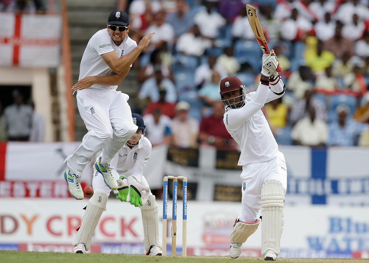 England captain Alistair Cook jumps to avoid being hit by a shot played by West Indies’ Marlon Samuels, right, from a delivery of Moeen Ali during day one of their second Test match in Grenada, (Photo: AP)