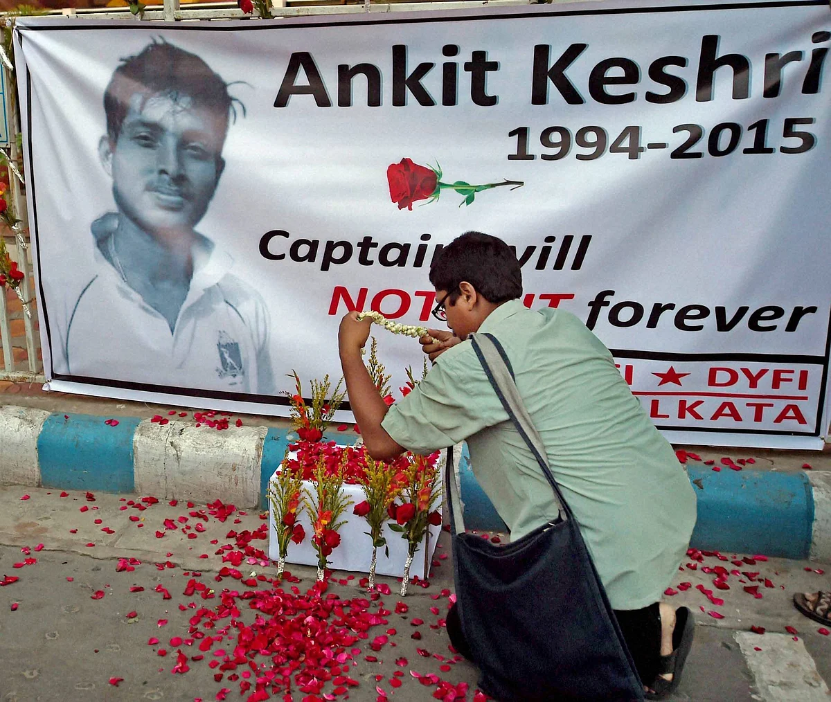 A man paying floral tribute to Bengal U-19 Cricketer Ankit Keshri, who died after sustaining an injury in a match, infront of CAB(Cricket Association of Bengal) in Kolkata on Tuesday. (Photo: PTI)