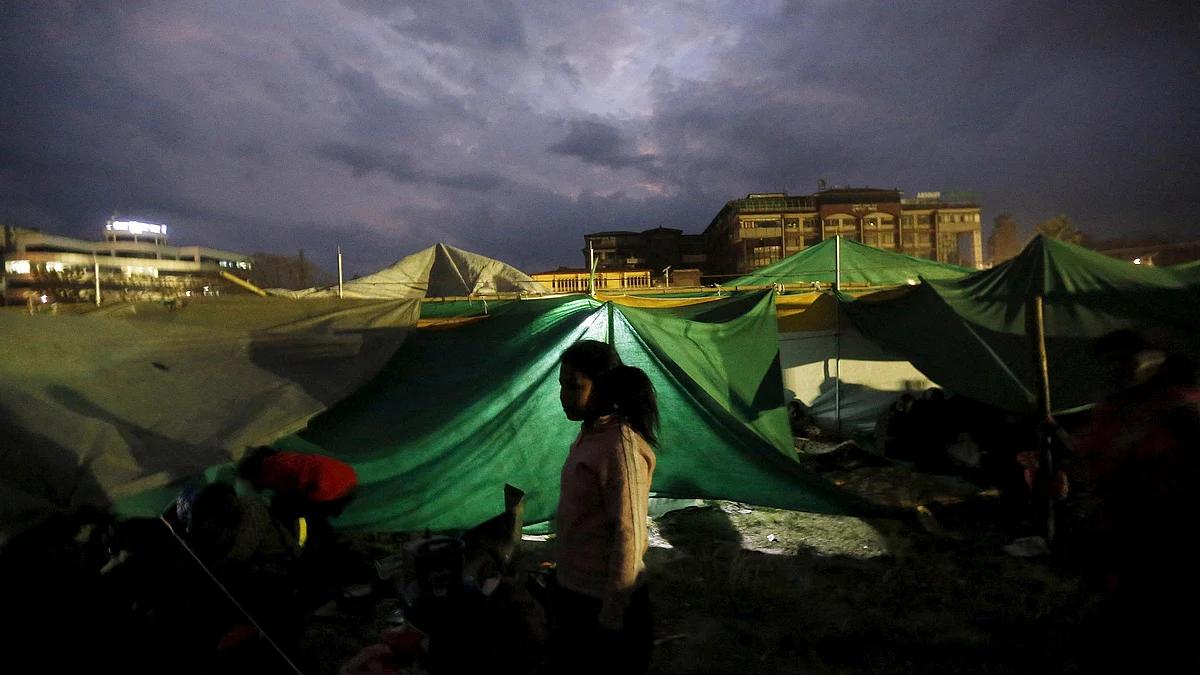 A girl stands outside her makeshift shelter at an open ground after an earthquake in Kathmandu, Nepal on April 26, 2015. (Photo: Reuters) 