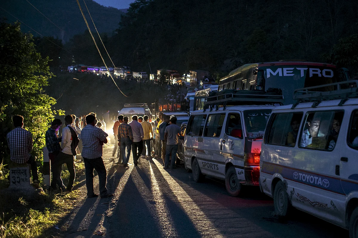 <!--StartFragment-->People gather on a road as traffic is affected by a landslide caused by an earthquake, in Kurintar, Nepal. (Photo: Reuters)<!--EndFragment-->