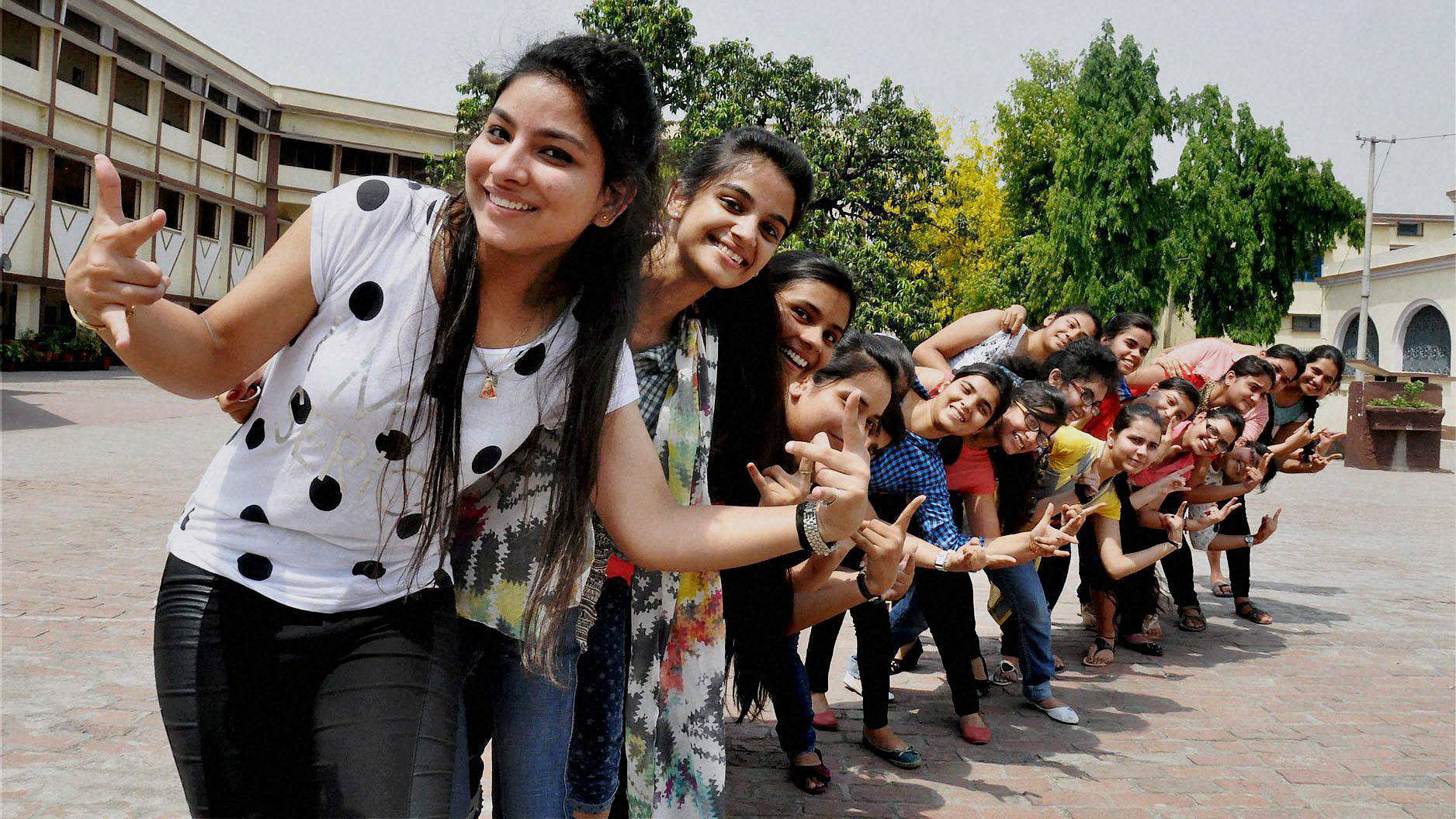 Girl students celeberate their success at a school after CBSE announced its 12th class results in Moradabad. (Photo: PTI)