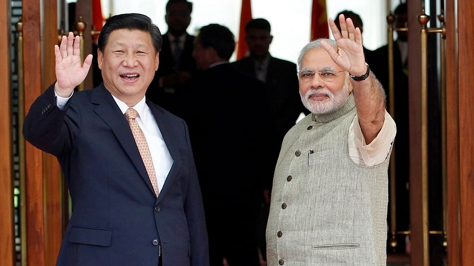 File photo of Prime Minister Narendra Modi (R) and China’s President Xi Jinping waving to the media. (Photo: Reuters)