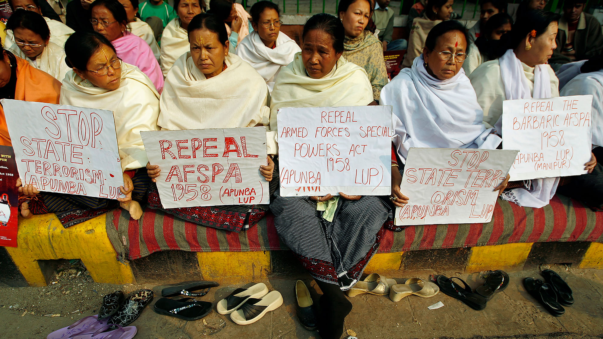 Women hold placards during a protest against the Armed Forces Special Powers Act (AFSPA).