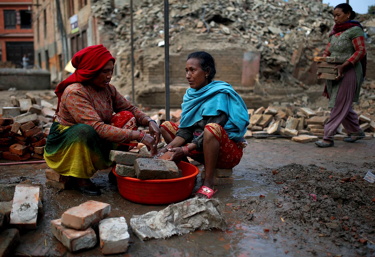 Women wash usable bricks which they found from collapsed houses after the earthquake, in Bhaktapur, Nepal. (Photo: Reuters)
