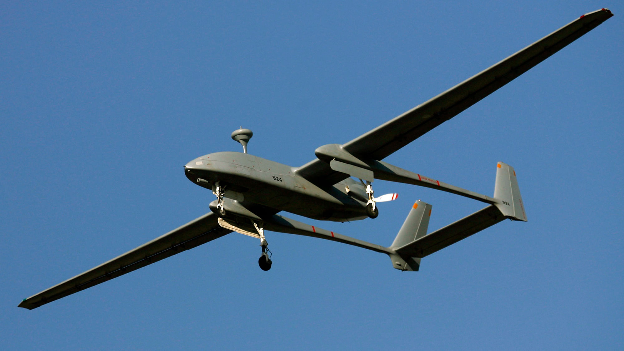 An Israeli-made Heron unmanned aerial vehicle (UAV) flies over Porbandar, during its commissioning into the Indian Navy.