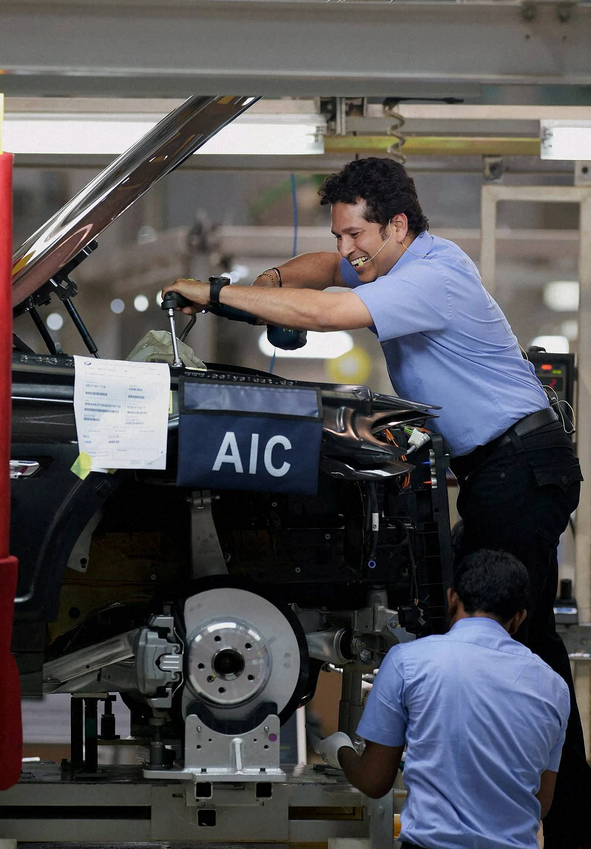 Sachin Tendulkar assembling a BMW 5 Series car at the company’s Mahindra World City plant near Chennai. (Photo: PTI)