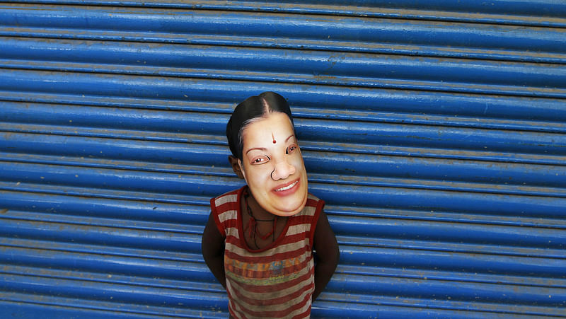 A boy wears a mask of Tamil Nadu Chief Minister J Jayalalithaa during an election campaign ahead of the general elections in Chennai, March, 2014. (Photo: Reuters)