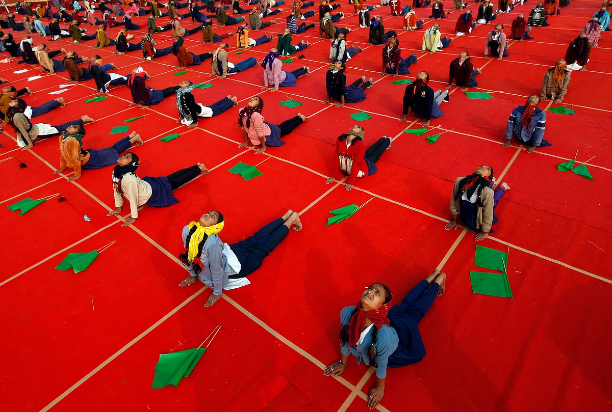 School girls attend a yoga session. (Photo: Reuters)