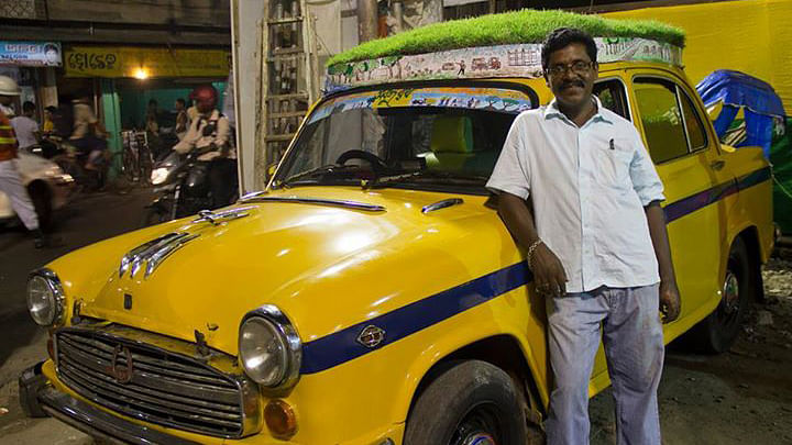 40-year-old driver Dhananjay Charkaborty who operates the ‘plant fitted’ car calls it his ‘Sobuj Rath’ or Green Chariot. (Photo Courtesy: Facebook.com/<a href="https://www.facebook.com/profile.php?id=100008750044564">Bapi Green Taxi</a>)