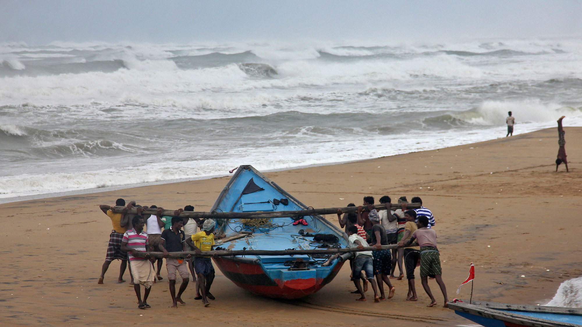 Fishermen seen moving a boat (Photo: Reuters)