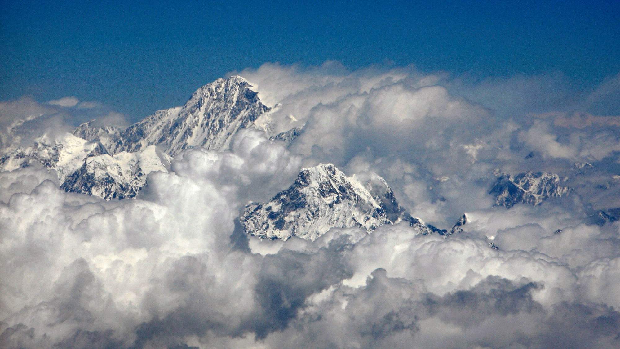 Mount Everest, the highest peak in the world, with an altitude of 8.848 metres (29.028 ft) is seen in this aerial view next to 6.812 metres (22.349 feet) high Mount Ama Dablam (bottom right).&nbsp;