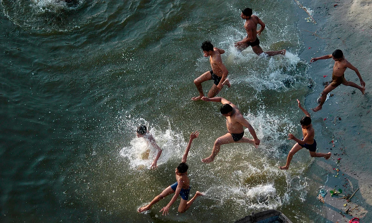 Boys play in the waters of the River Ganges in Allahabad to get respite from the heat. (Photo: Reuters)