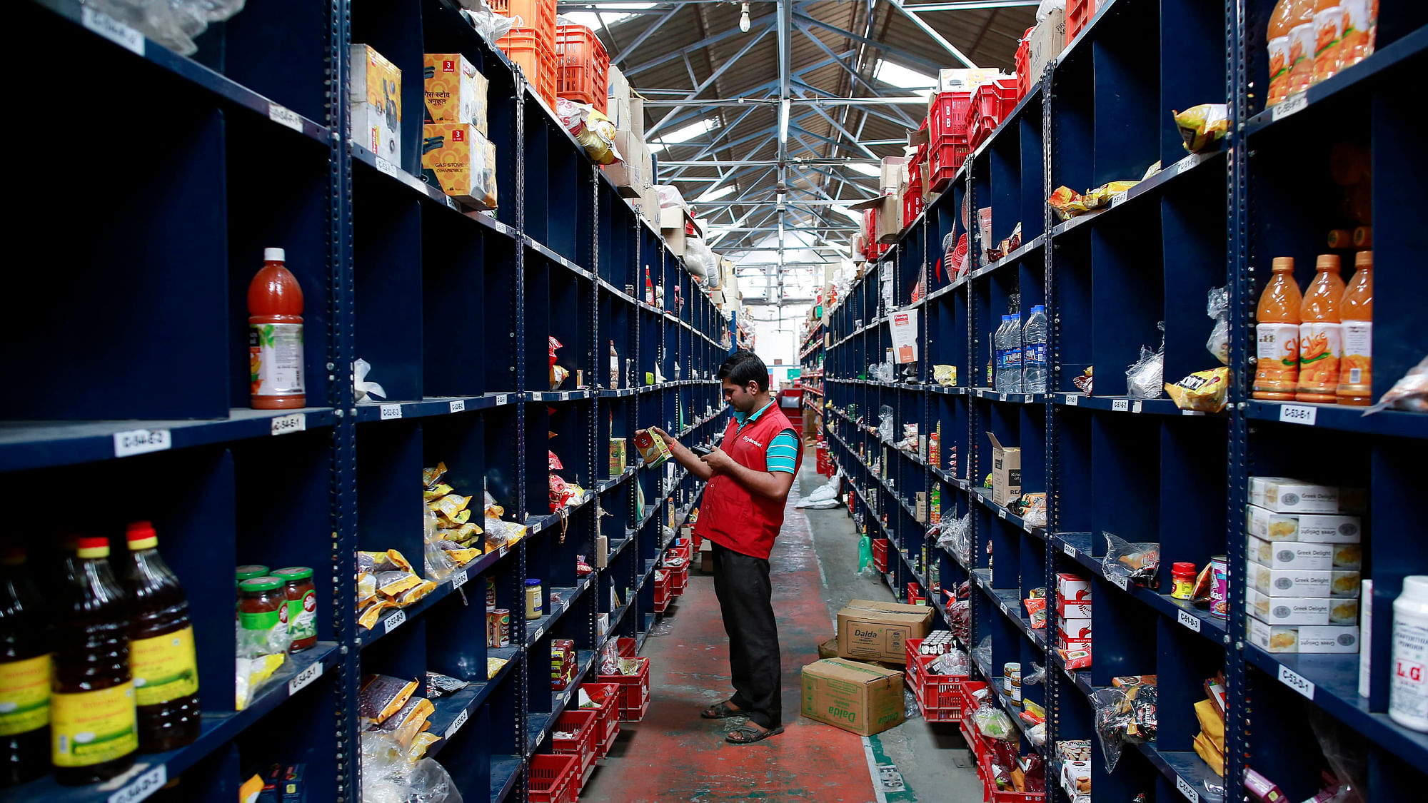 An employee scans a package for an order at a Big Basket (an online groceries firm) warehouse on the outskirts of Mumbai.