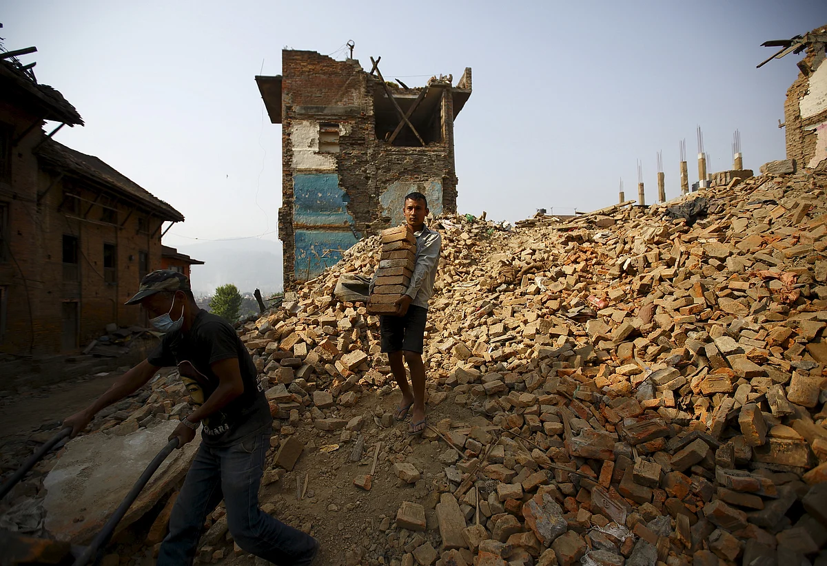 A man carries bricks from collapsed houses, a month after the April 25 earthquake in Bhaktapur, Nepal. (Photo: Reuters)