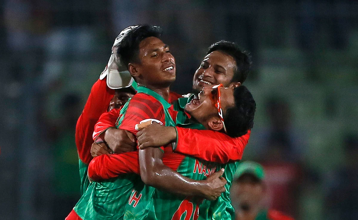 Bangladesh’s Mustafizur Rahman, left, celebrates with teammates Nasir Hossain, right, and Shakib Al Hasan, center, the dismissal of Ravichandran Ashwin. (Photo: AP)