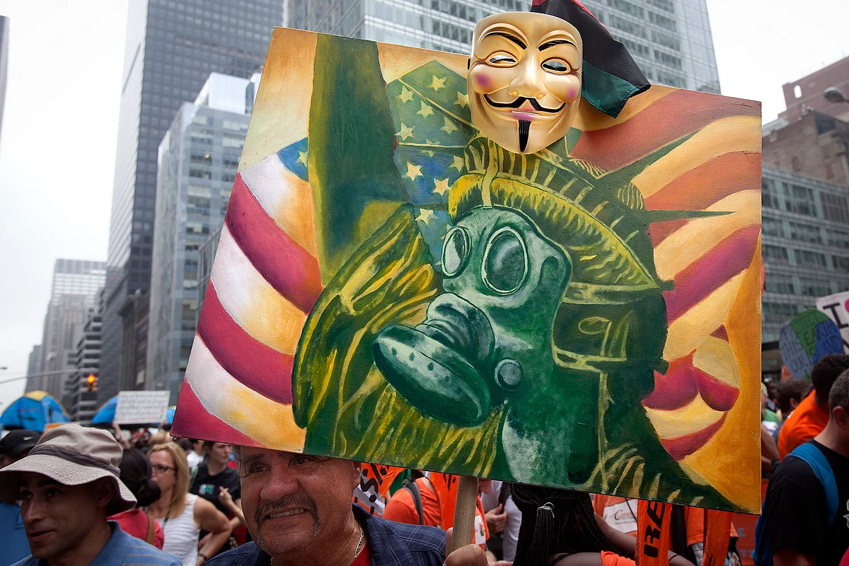 A protester carries a sign with an image of the Statue of Liberty wearing a gas mask as he takes part in the “People’s Climate March” down 6th Ave. in the Manhattan borough of New York, September, 2014. (Photo: Reuters)