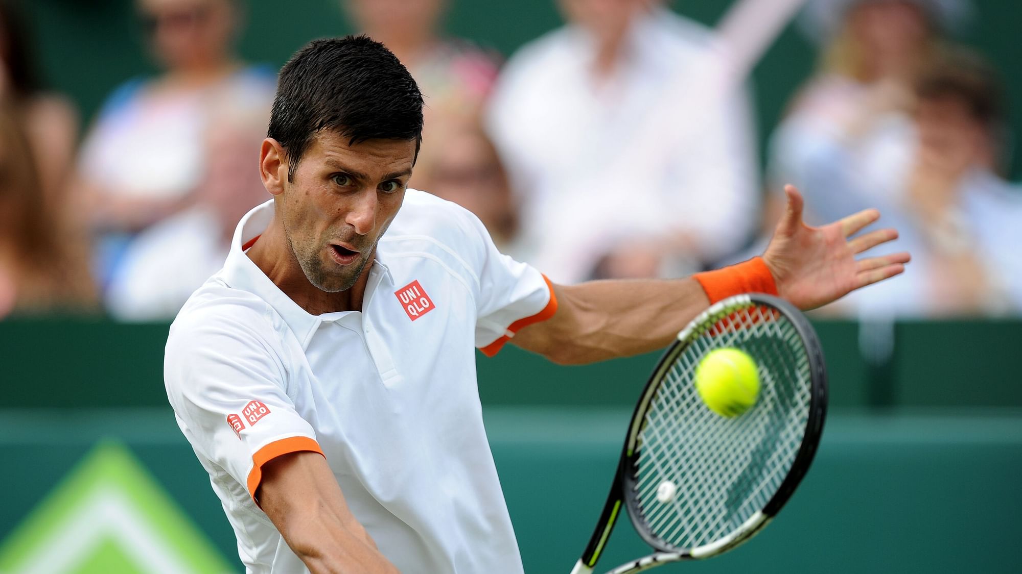 Novak Djokovic returns a shot in an exhibition match before the Wimbledon. (Photo: AP)