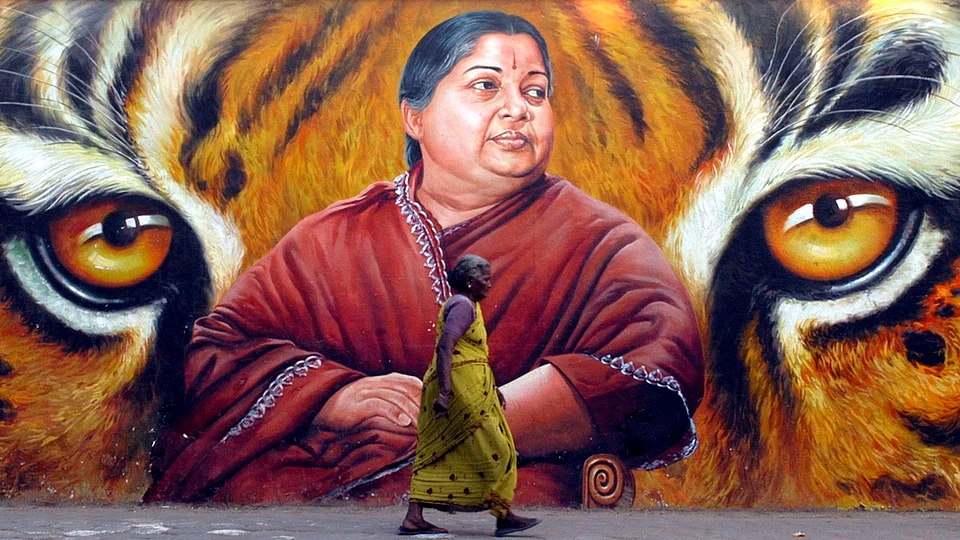 A woman walks past a poster of Tamil Nadu Chief Minister J Jayalalitha (Photo: Reuters)