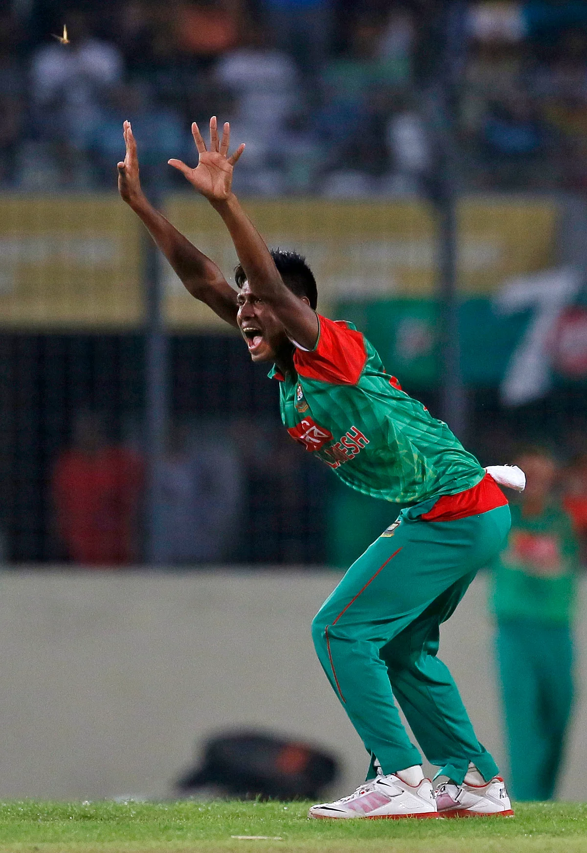 Bangladesh’s Mustafizur Rahman celebrates the dismissal of India’s Rohit Sharma.