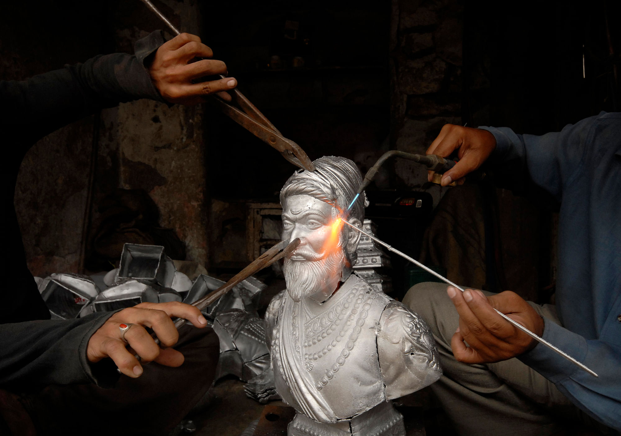 Craftsmen prepare a statue of Chhatrapati Shivaji, revered by many in western India as a Hindu warrior king who fought the Mughal empire and annexed land from its Muslim rulers in the 17th century, at a metal casting workshop in the southern Indian city of Hyderabad July 1, 2008