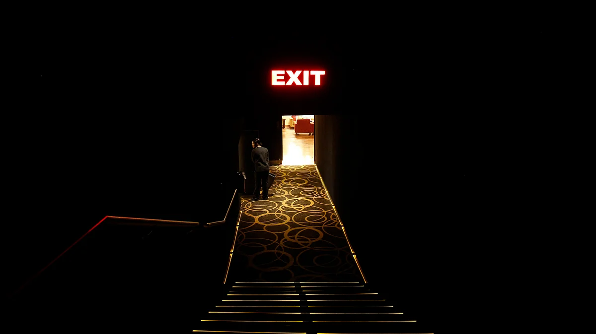 An employee cleans a theatre during an interval at a multiplex in Mumbai. 