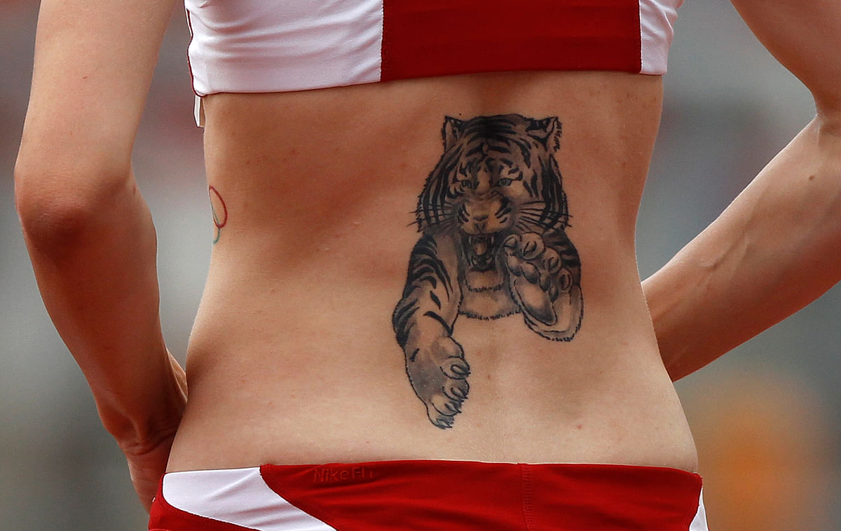 A tattoo of a tiger is seen on the back of Germany’s Ariane Friedrich during the women’s high jump competition at the German athletics championships in Braunschweig. (Photo: Reuters)