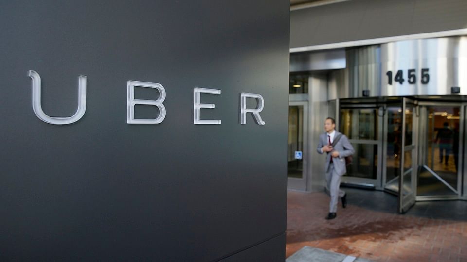 A man leaves the headquarters of Uber in San Francisco. (Photo: AP)