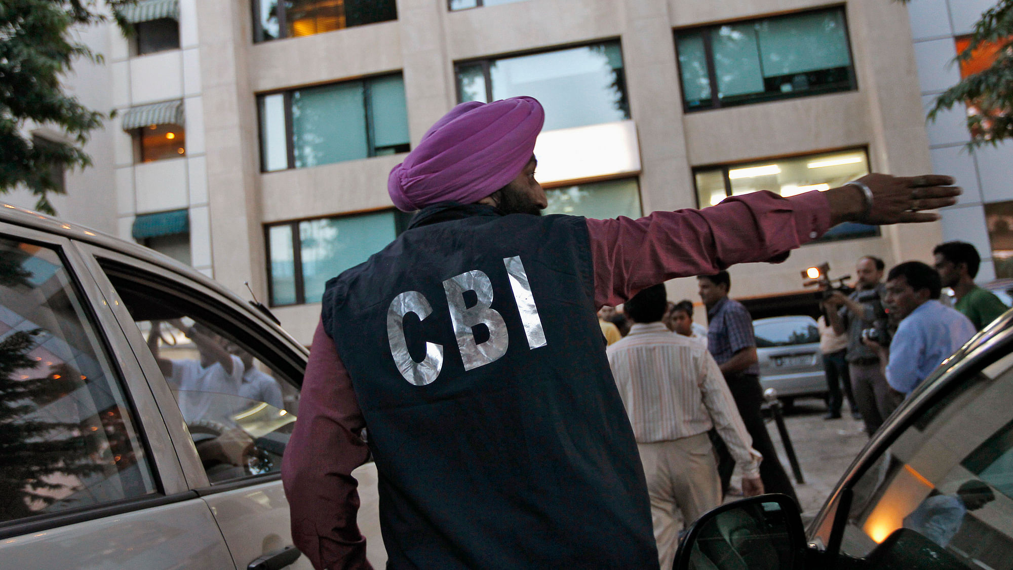 A Central Bureau of Investigation (CBI) official gestures after conducting a raid in New Delhi.
