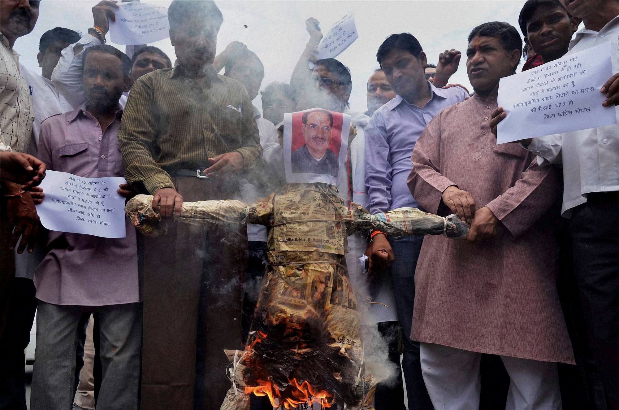 Congress activists burning an effigy of Madhya Pradesh Chief Minister Shivraj Singh Chouhan in Bhopan on Monday. PTI photo