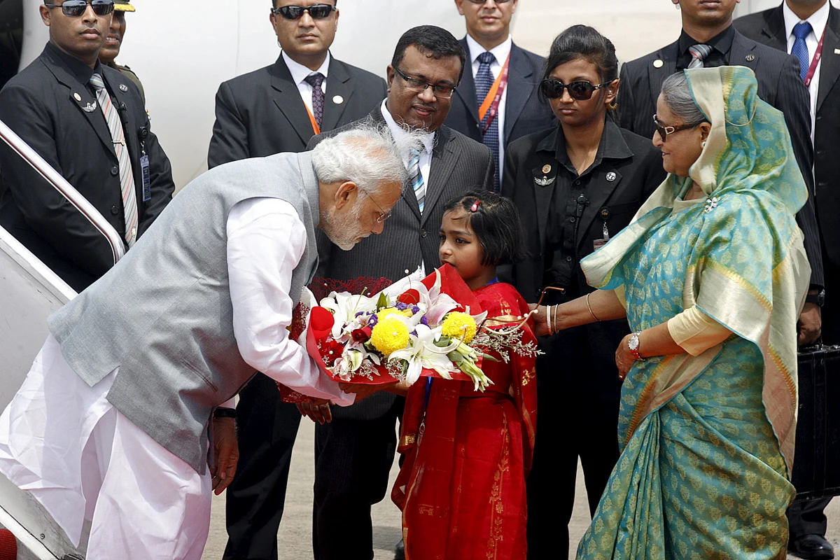 India’s Prime Minister Narendra Modi receives flowers while greeted by Bangladesh’s Prime Minister Sheikh Hasina. (Photo: Reuters)