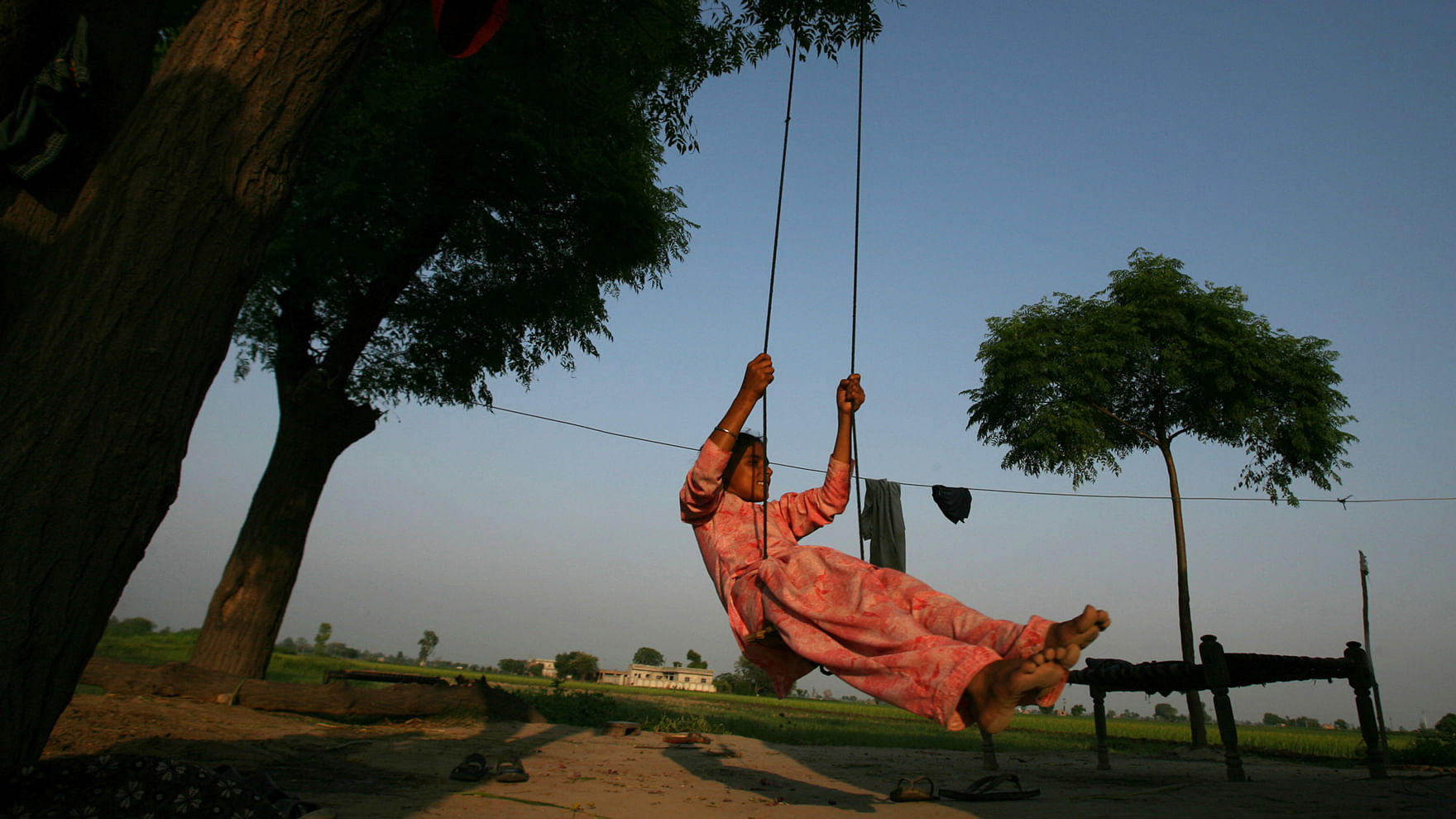 A little girl on a swing. (Photo: Reuters)