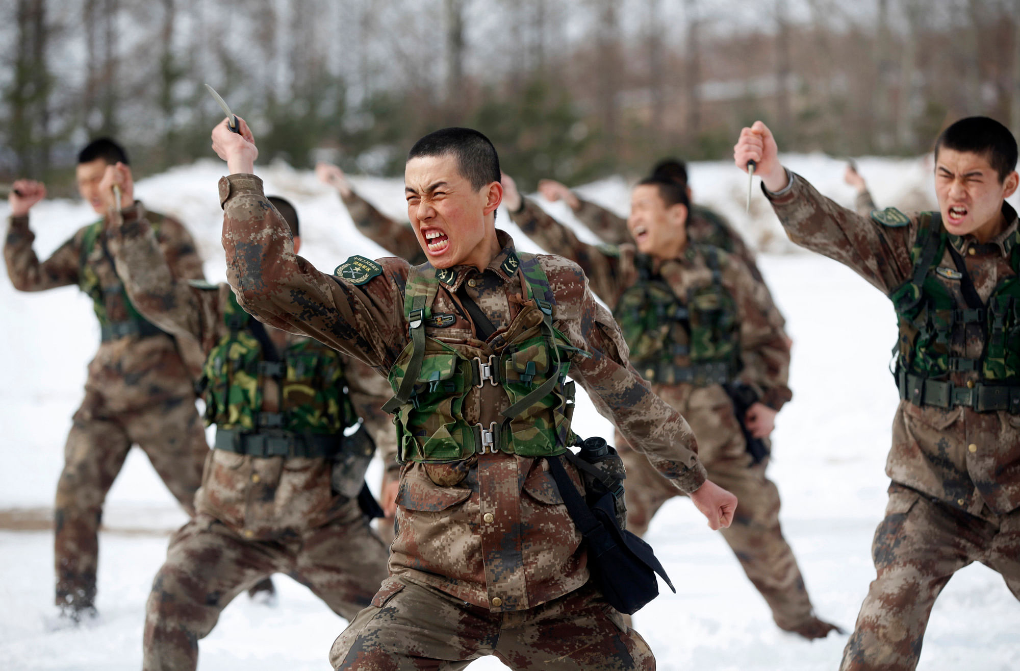

<!--StartFragment-->People’s Liberation Army (PLA) soldiers shout as they practise with knives during a training session on snow-covered ground at a military base. (Photo: Reuters)<!--EndFragment-->