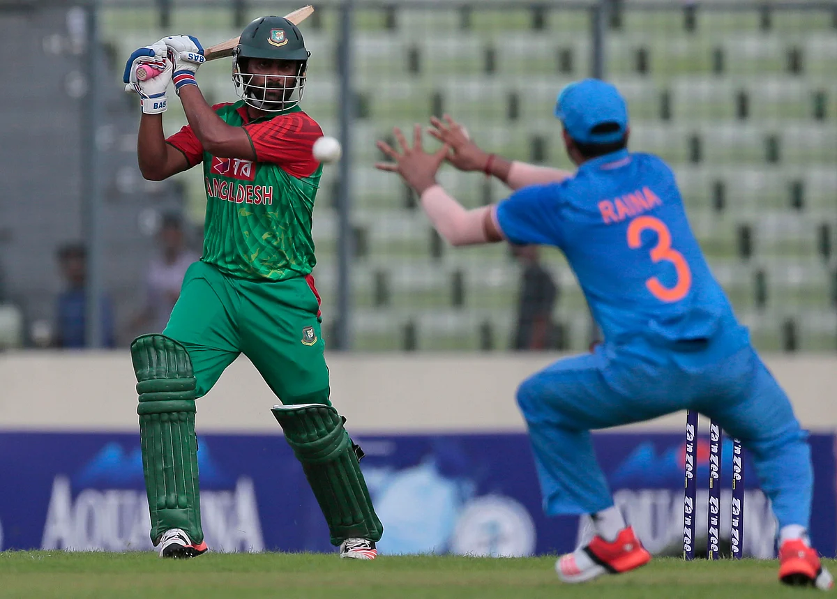 Bangladesh’s Tamim Iqbal, left, plays a shot, as India’s Suresh Raina attempts to field. (Photo: AP)