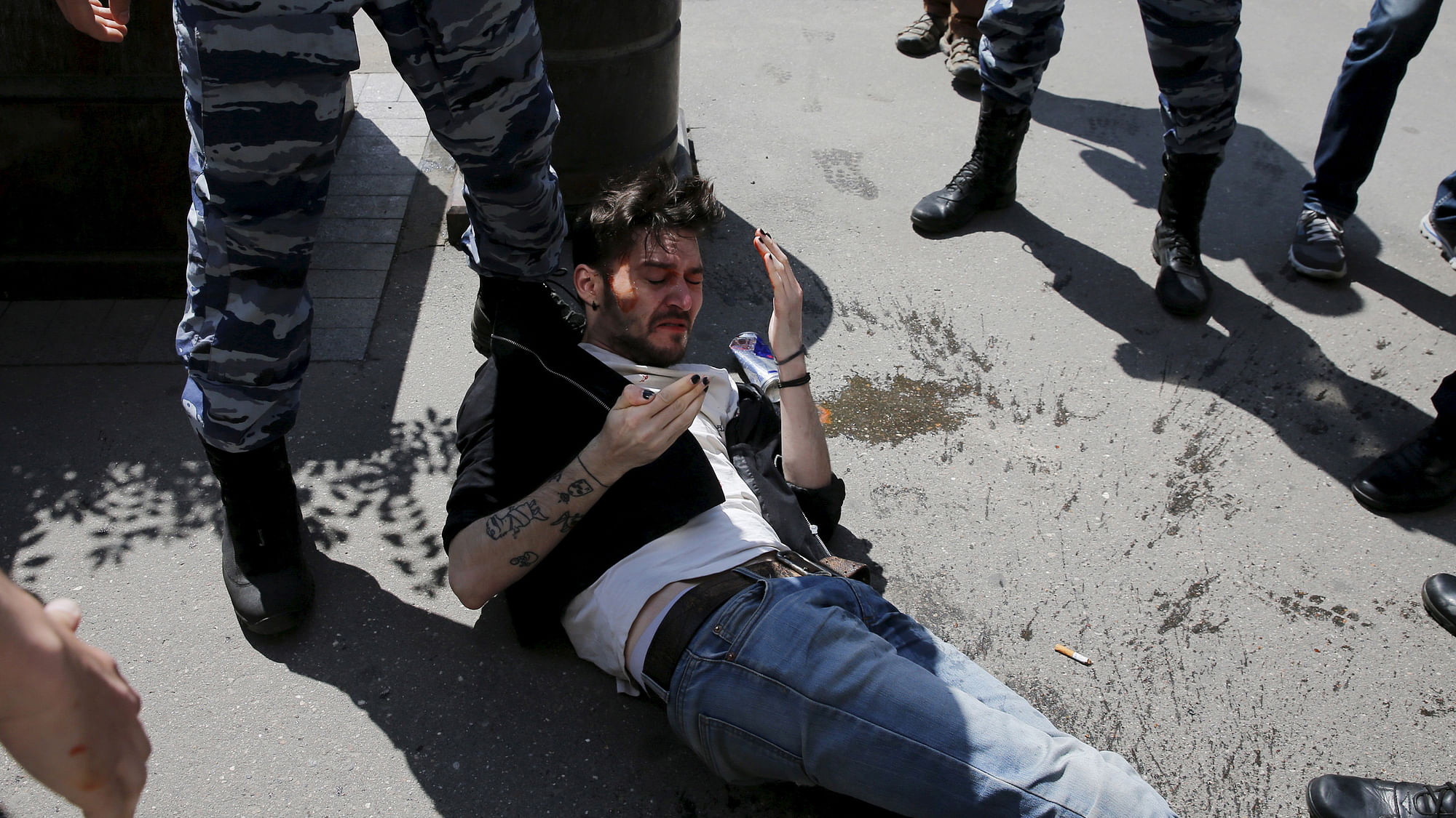 















 A gay rights activist lies on ground after being attacked by
anti-gay protesters during an LGBT (lesbian, gay, bisexual, and transgender)
community rally in Russia (Photo: Reuters) 