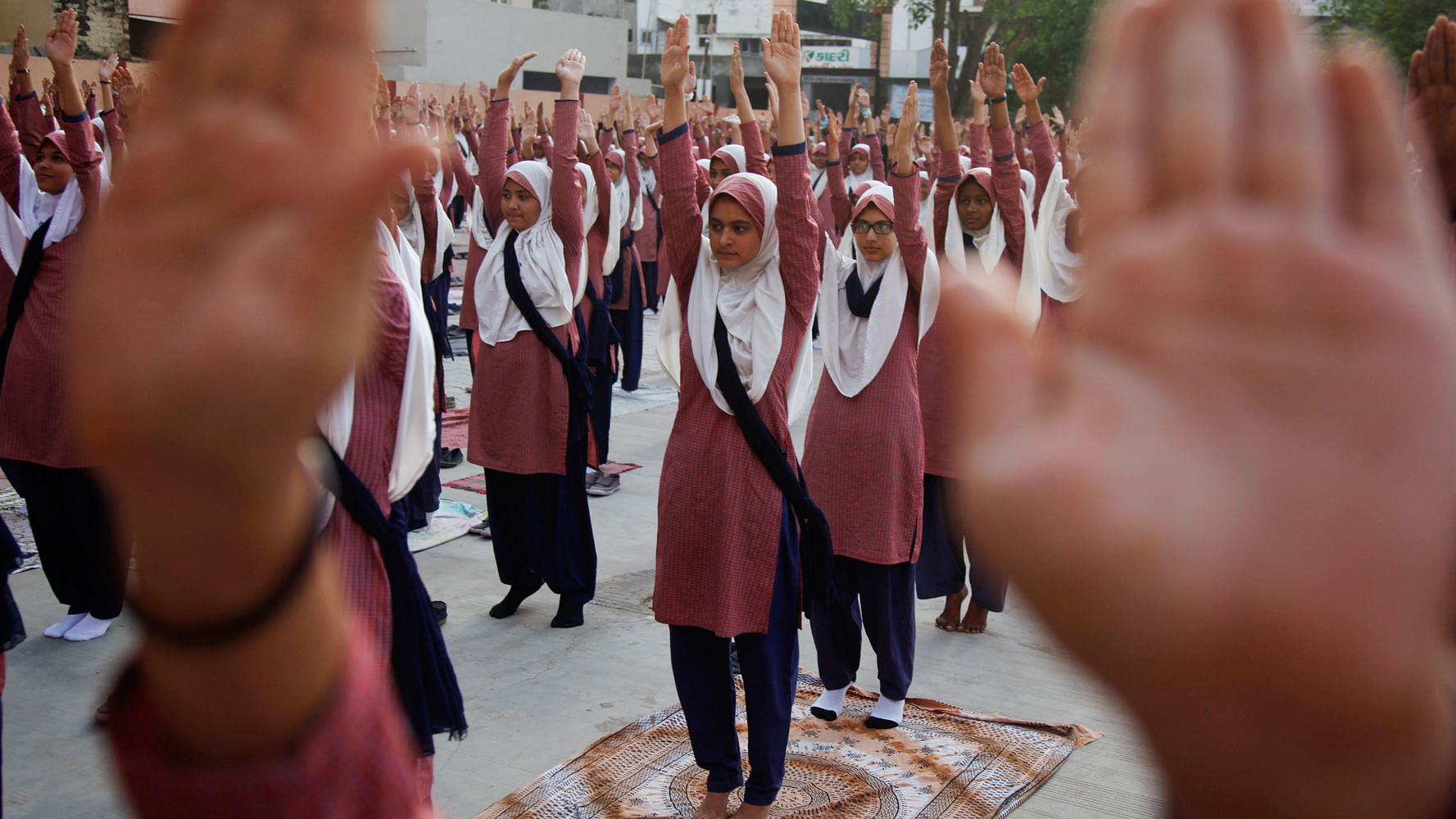 Students practice yoga at a school in Ahmadabad.(Photo: AP)