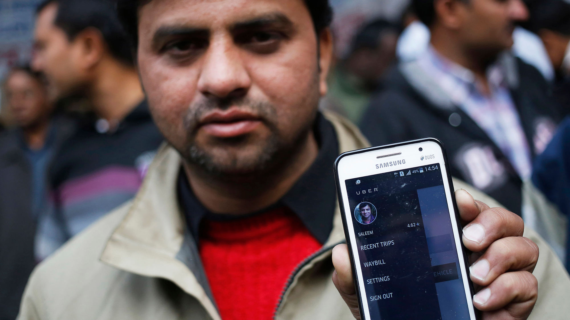 An Uber taxi driver shows the application software in his mobile phone. (Photo: Reuters) 