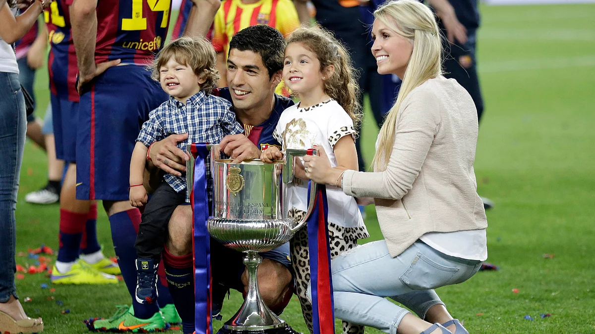 Luis Suarez gets photographed with his family after the King’s Cup victory in May. (Photo: AP)
